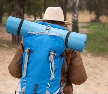 Large orange camping backpack with multiple external pockets