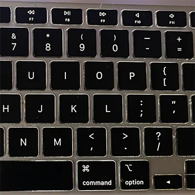 Backlit laptop keyboard glowing softly, showing illuminated keys